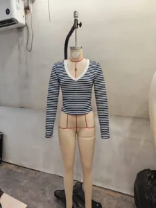 Close-up detail view of the blue and white striped V-neck long sleeve top on tailor mannequin.