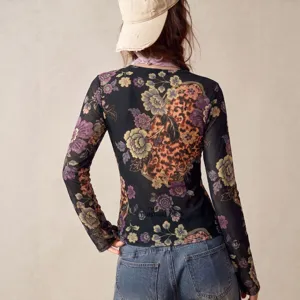 Detailed view of the floral print long sleeve mesh top showing back design and fabric.