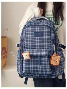 Close-up of the blue plaid school backpack showing detailed pocket, cute toast pendant and straps.