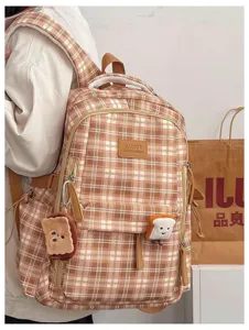 Detailed view of vintage plaid school backpack with cute toast plush charms, large capacity.