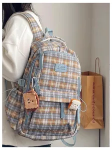 Retro plaid backpack detail view featuring cute toast plush pendants and large capacity.