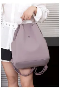 Detail view of Korean lightweight nylon women backpack, casual travel daypack in light purple.