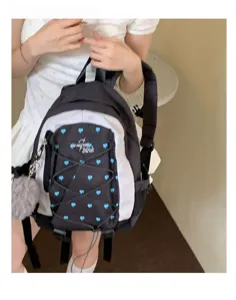 Korean style contrast backpack detail featuring blue heart patterns and cute fluffy pendant.