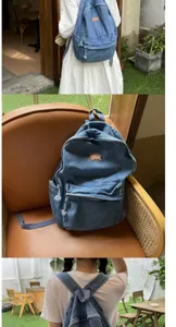 Zaino in denim lavato vintage coreano con grande capacita, ideale per studenti e uso quotidiano.