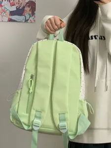 Cute canvas backpack with shoulder straps and front pocket for daily school student use.
