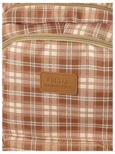 Detailed view of the vintage brown plaid backpack featuring smooth zippers and a branded label.