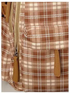Vintage plaid backpack detail view, brown checkered school bookbag with front pocket and durable zippers.