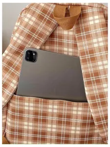 Brown plaid backpack detail view, featuring durable fabric and spacious front pocket design.