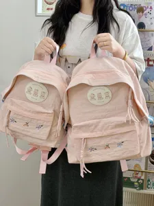 Bonita mochila escolar rosa con bonito parche de oso y bordado fino para uso diario.