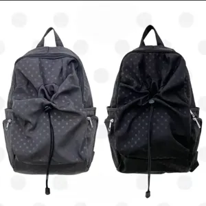 Detailed close-up view of the casual polka dot backpack showing the front drawstring pocket.
