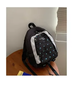 Details of the Korean style contrast color backpack with blue hearts and stylish front cords.