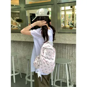 Korean ins style pink polka dot backpack, lightweight cute student school bag for daily use.
