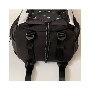 Backpack detail view showing contrast color, black and white fabric with blue heart pattern.