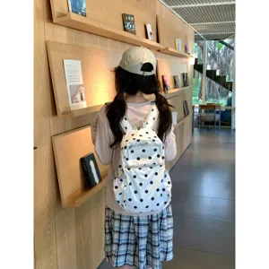 Korean style polka dot backpack lifestyle detail shot showing cute aesthetic design and straps.