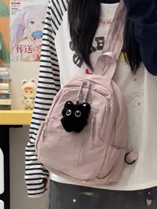 Cute pink mini casual backpack detail showcasing front zipper pocket and adorable black cat plush charm.