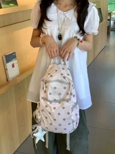Cute pink polka dot backpack with front pocket and star pendant for casual daily use