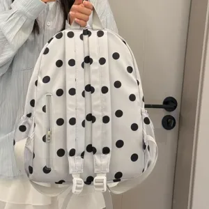 Detailed view of the Korean style polka dot backpack back straps and zipper pocket.