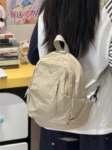 Casual lightweight nylon backpack and crossbody bag with multiple zip pockets for daily travel.