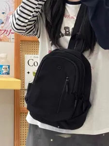 Casual small black backpack and chest bag for travel, lightweight and versatile daypack.