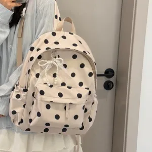 Detail shot of a cute beige polka dot backpack with lace pearl bow for daily wear and school.