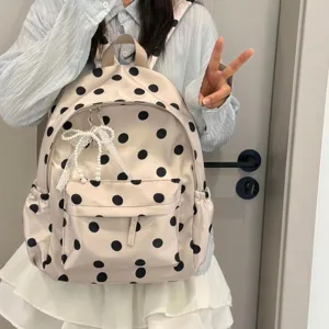 Detail view of Korean polka dot backpack, showing cute lace pearl bow and smooth zipper.