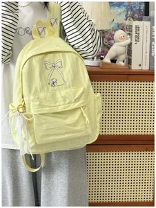 Zaino giallo carino in stile coreano con ricamo a fiocco, grande capacità borsa da scuola.