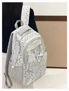 Detail shot of Korean style cute polka dot backpack with star pendant and small coin purse.