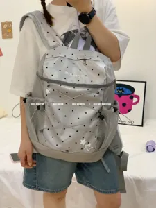 Grey polka dot backpack with mesh side pockets, stylish Korean style school book bag for daily use.