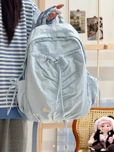 Light blue ruffled backpack detail view, casual college style daily school bag close up.