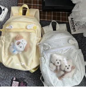 Cute polka dot transparent backpack for girls, large capacity school bag with clear doll pocket.