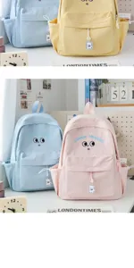 Cute canvas school backpack with cartoon eyes embroidery and bear pendant for girls.