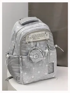 Grey polka dot school backpack detail view with cute bear coin pouch and star charm