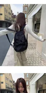 Casual black backpack for women and men, stylish polka dot school bag, lightweight travel daypack.