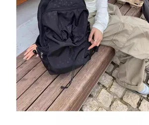 Korean style subtle polka dot casual backpack for women and men, lightweight daily travel school bag.