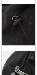 Close-up detail of black polka dot casual backpack, showing fine zipper and drawstring.