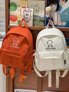 Cute cartoon dog canvas backpack detail, stylish schoolbag for students and daily casual wear.