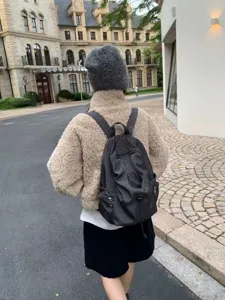 Korean style polka dot casual backpack for women and men, lightweight daily travel schoolbag.