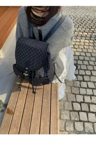 Korean style casual canvas backpack with cute white star pattern, outdoor lifestyle detail shot.