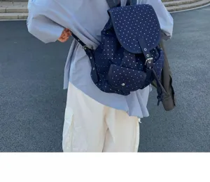 Detailed shot of dark blue star print backpack, casual campus style, everyday wear scene.