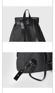 Detailed view of black backpack with white stars, featuring leather straps and metal buckles.