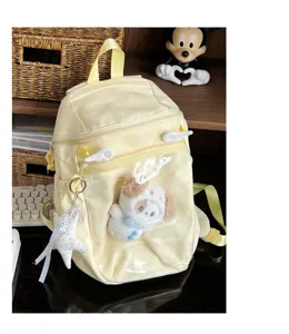 Transparent polka dot girl school backpack with cute plush doll, lightweight student bag.