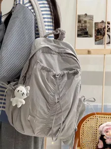 Korean style pleated backpack for girls, lightweight travel bag with cute bear pendant detail.