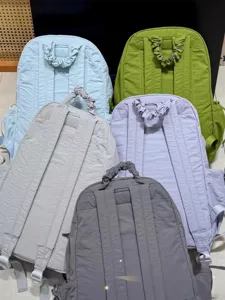 Detailed view of casual nylon backpacks in multiple colors featuring cute scrunchie handles.
