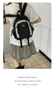 Casual mini backpack detail shot featuring cute blue heart pattern and front pocket design.