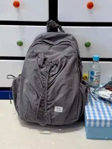 Korean style pleated casual backpack detail view showing soft grey fabric and drawstring design.