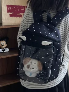 Black polka dot ita backpack with clear front pocket and cute wings for schoolgirls.