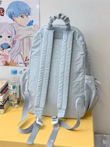 Detailed view of the light blue casual ruched backpack showcasing adjustable straps and texture.