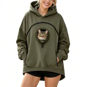 Detail view of the green pet pouch hoodie with a cute cat peeking out from the front window.