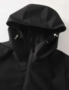 Close-up detail of black men's hooded windbreaker, featuring metal drawstrings and mesh.