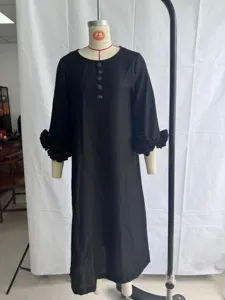 Detailed view of black cotton linen long dress featuring 3d flower cuffs and vintage buttons.
